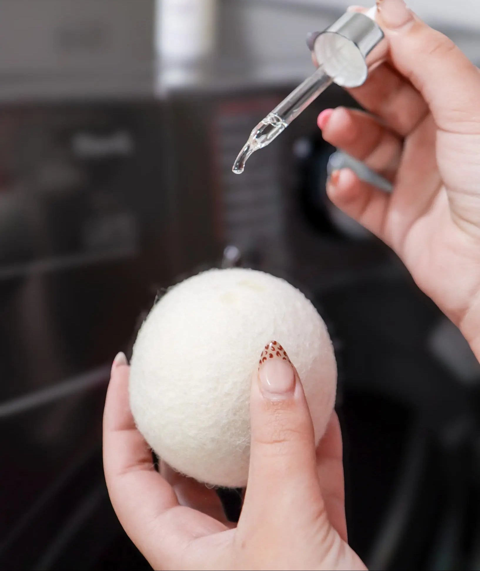 1 Oz. Scent Booster Purple Duck being applied to a dryer ball